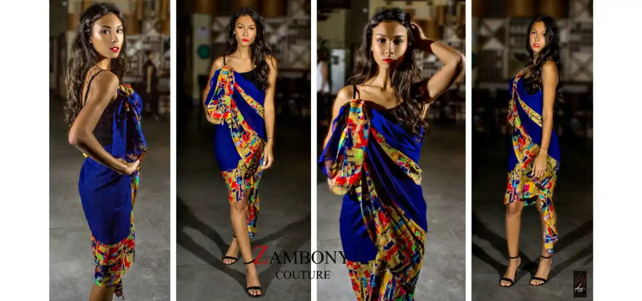 A royal blue fitted dress with a colorful, flowing fabric overlay.