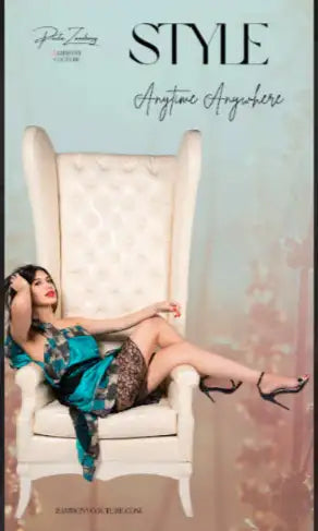 Cream wingback chair with tufted upholstery and ornate floral pattern on the backrest.