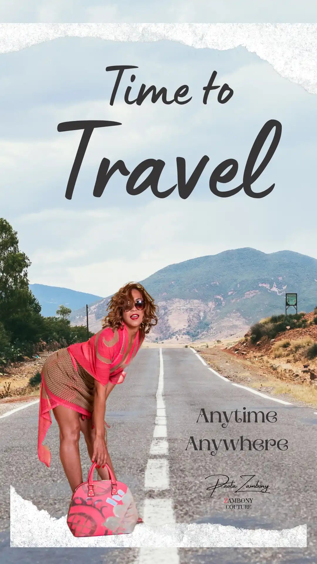 A woman in a stylish outfit with a matching pink handbag on an open road.